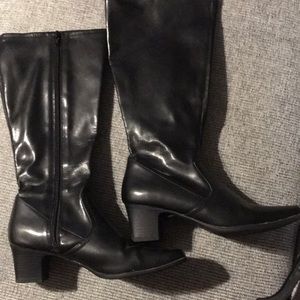 Knee high black leather boots.